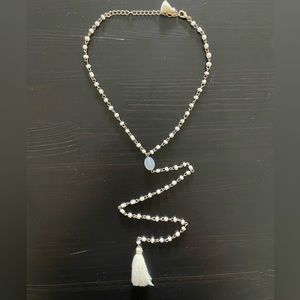 White and gold necklace with tassel